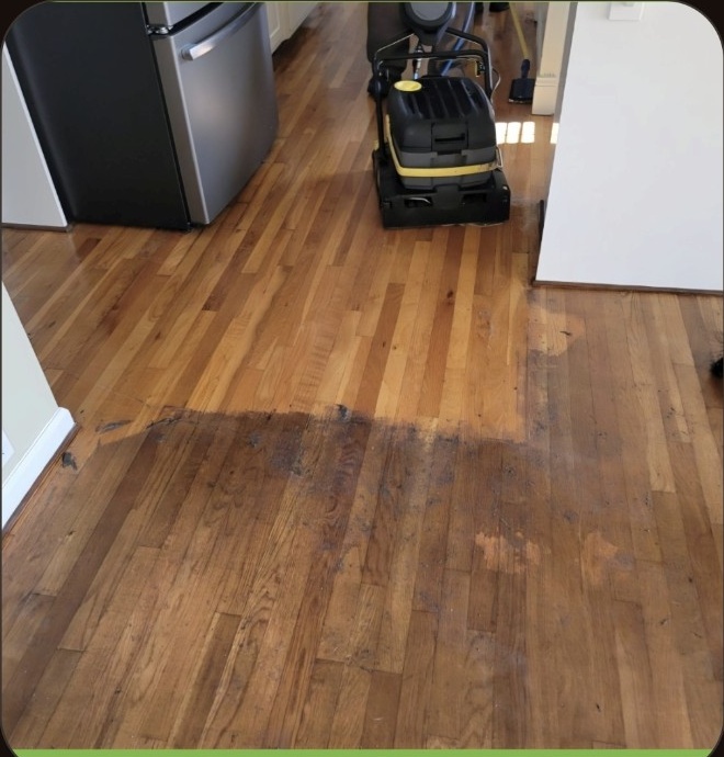 Lighter natural hardwood floor revealed after buildup removal