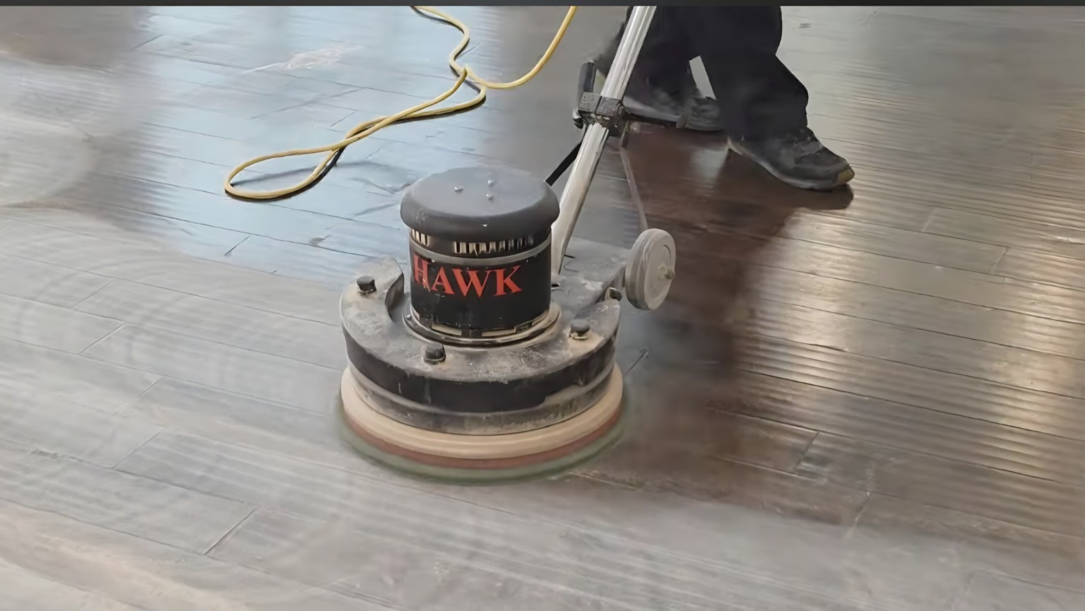 Screening a hardwood floor with a professional floor buffer